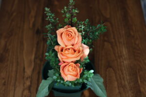 yellow, peach, orange rose arrangement that follow the American Rose Society guidelines for a straight-line design.