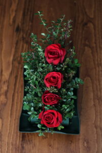 red rose arrangement that follow the American Rose Society guidelines for a straight-line design.